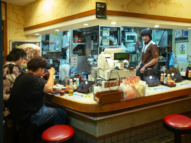 Typický japonský podnik s pultovým sezením a otevřenou kuchyní v Tokiu.
